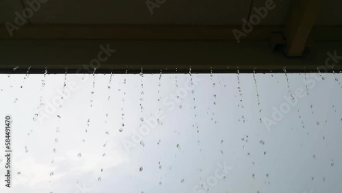 Rain is dropping on the roof, Heavy rain drop down on eaves in raining day.