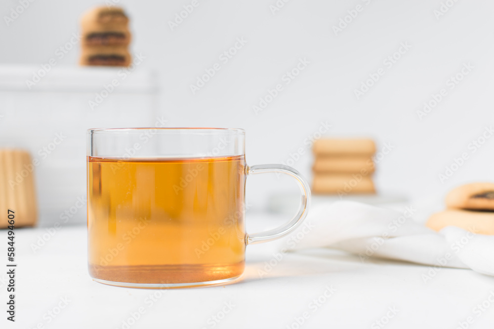 Tea in a glass cup, freshly brewed black tea in a trendy glass cup