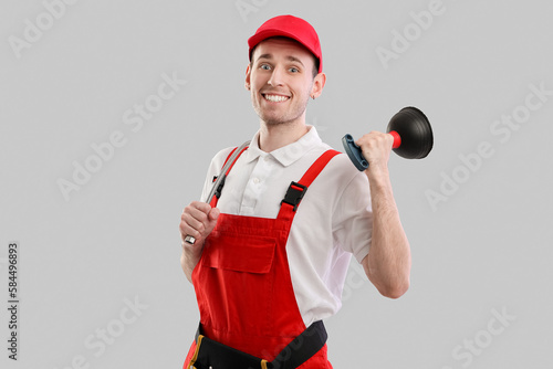 Male plumber with plunger o...