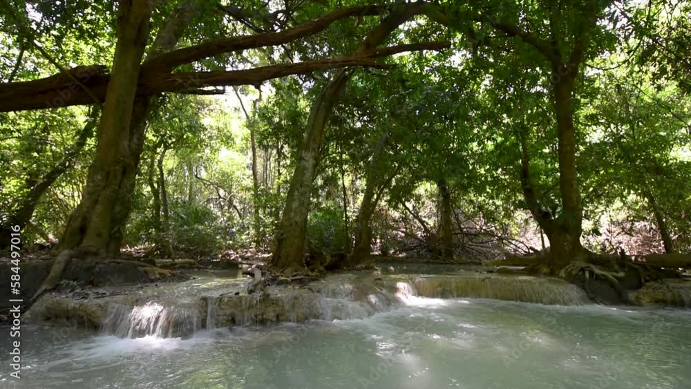 Wild mountain river flowing with stone boulders and stone rapids, Splashing water in creek, Morning sun breaks through the trees. Wild mountain river flowing with stone boulders and stone rapids, Splashing water in creek, Morning sun breaks through the trees.