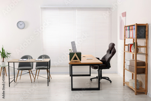 Director's office with large wooden table and comfortable armchairs. Interior design © New Africa