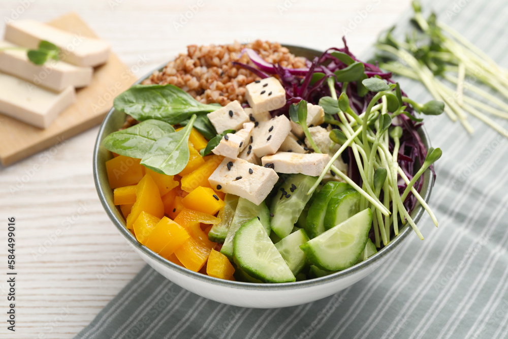 Delicious vegan bowl with bell pepper, tofu and cucumbers on wooden table, closeup Delicious vegan bowl with bell pepper, tofu and cucumbers on wooden table, closeup
