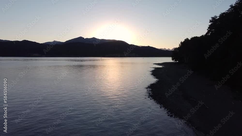 Cinematic establishing shot moving backwards from the lake Nahuel Huapi at sunset in Villa La Angostura, Patagonia Argentina. Cinematic establishing shot moving backwards from the lake Nahuel Huapi at sunset in Villa La Angostura, Patagonia Argentina.