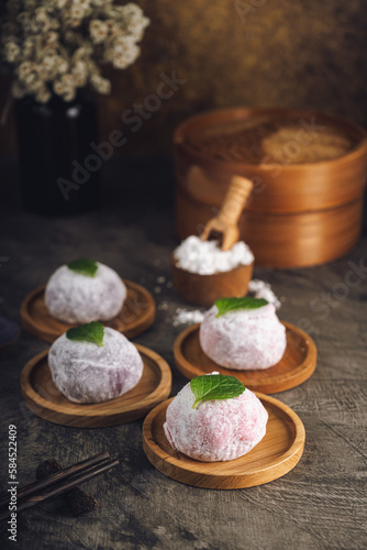 Japanese mochi or rice cake filled with red bean and strawberry, mint leaves on top. Japan traditional rice cake.