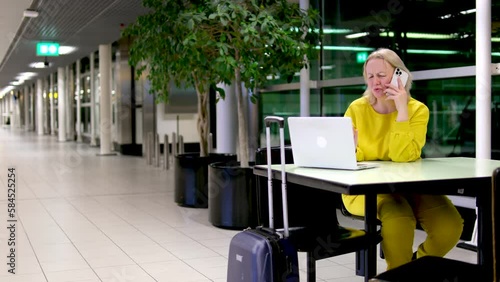 Airport Terminal Woman Waits for Flight, Uses Smartphone, Receives Shockingly Bad News, Misses Flight Upset, Sad, and Dissappointed Person Sitting in a Boarding Lounge of Airline Hub photo