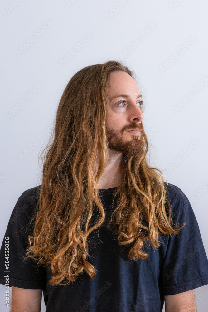 Fototapeta premium Blond long hair white man wearing black t shirt on white background