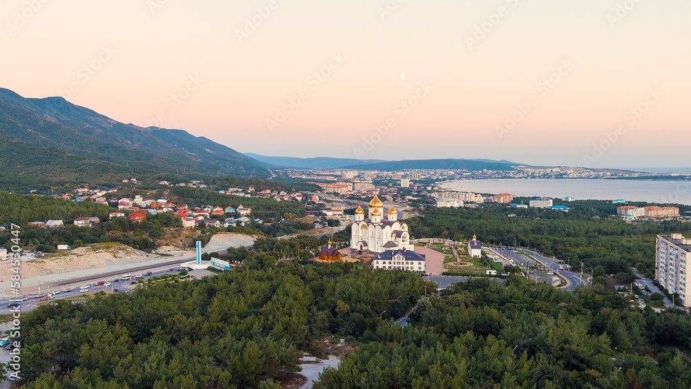 Gelendzhik, Russia. Cathedral of St. Andrew the First-Called. The text at the entrance to the city is translated as Gelenzhik-City Resort. Sunset time, Aerial View