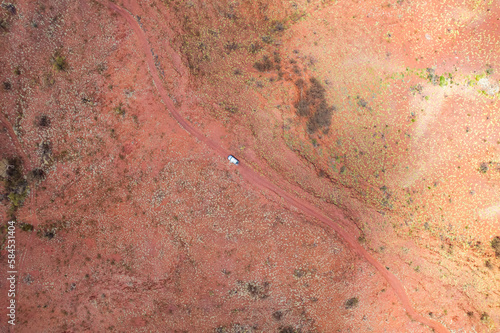 4WD car sitting stationary on a dusty red earth road in outback Australia photo