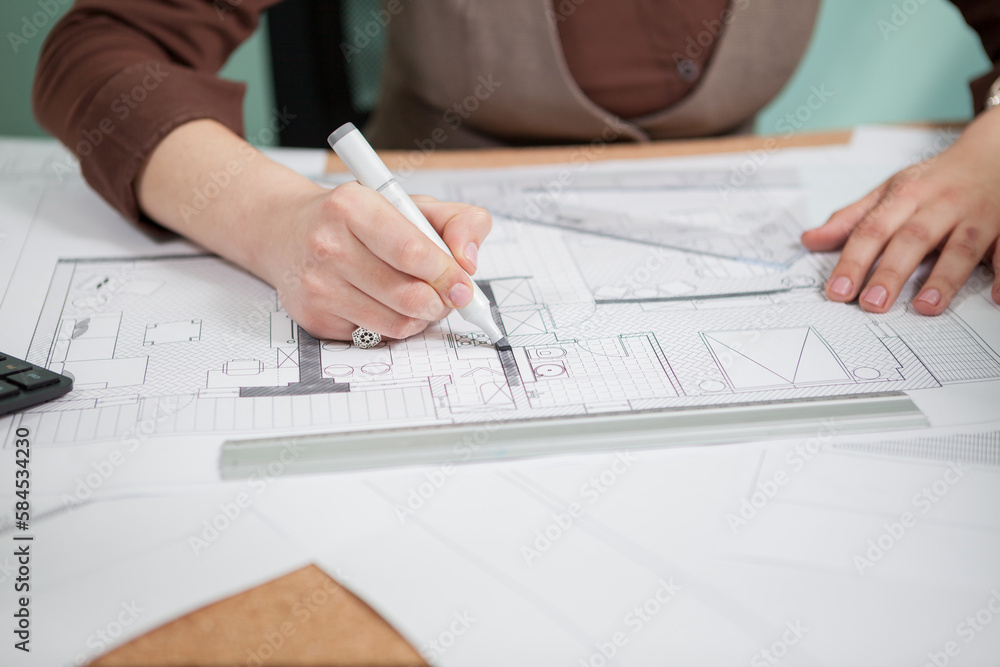 Architect woman at her table drawing on blueprints. Business and creativity. Architecture job Architect woman at her table drawing on blueprints. Business and creativity. Architecture job