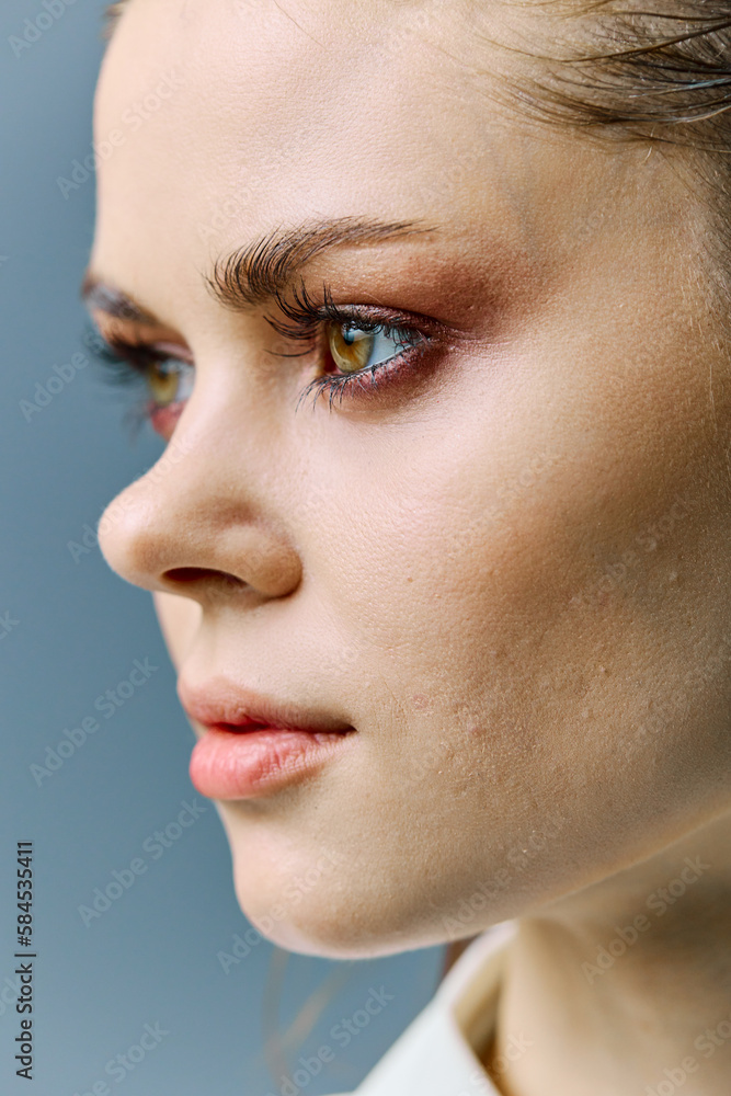 a close vertical portrait of a beautiful woman with neat evening makeup, and problematic skin, standing looking to the side. A photo from the fashion world without retouching a close vertical portrait of a beautiful woman with neat evening makeup, and problematic skin, standing looking to the side. A photo from the fashion world without retouching