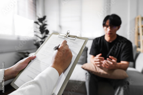 Mental health professional taking notes during a counselling session