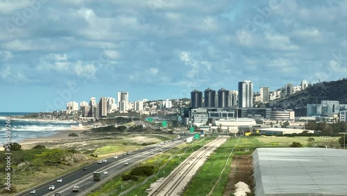 Southern entrance to Haifa in Israel north district, with city buildings and The Mediterranean Sea coastline photo