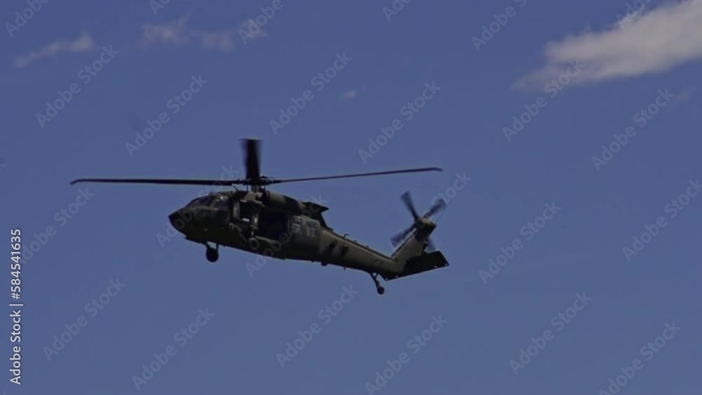 View Of Sikorsky UH-60 Black Hawk Flying In Air Against Blue Skies. Slow Motion, Tracking Shot View Of Sikorsky UH-60 Black Hawk Flying In Air Against Blue Skies. Slow Motion, Tracking Shot