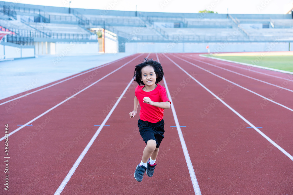 A girl athlete in training. Runner exercising. Jogging for kid.