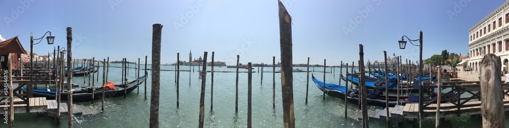 View with moored gondolas across the Venetian Lagoon from Piazza San Marco in Venice towards the Church of San Giorgio Maggiore