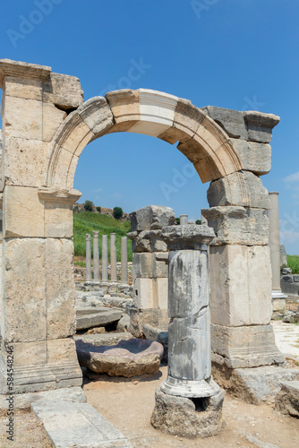 Perge, or Perga is ancient Anatolian city in Pamphylia. Colonnade and ruined Demetrios Apollonios arch. Antalya region, Turkey (Turkiye). Travel and ancient history concept photo