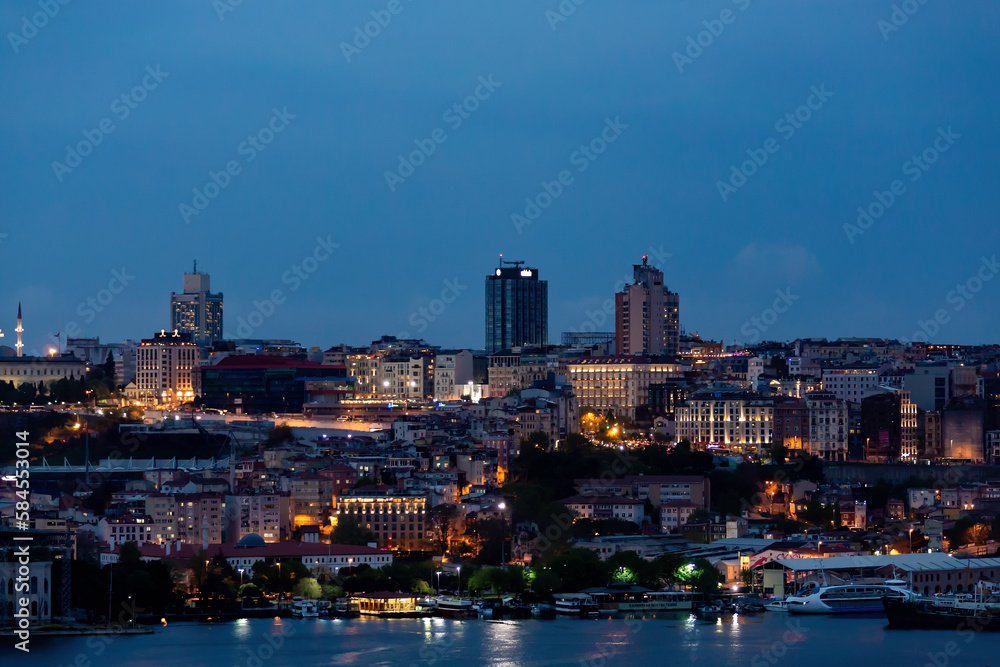 Defocused blurred panoramic view of Balat and Golden horn gulf during twilight time. Vibrant colors. Istanbul, Turkey (Turkiye). Cityscape background
