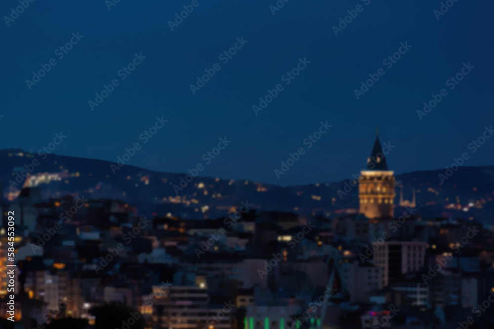 Defocused blurred panoramic view of Istanbul sityscape and galata tower during twilight time. Vibrant colors. Istanbul, Turkey (Turkiye). Cityscape background
