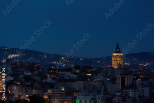 Defocused blurred panoramic view of Istanbul sityscape and galata tower during twilight time. Vibrant colors. Istanbul, Turkey (Turkiye). Cityscape background