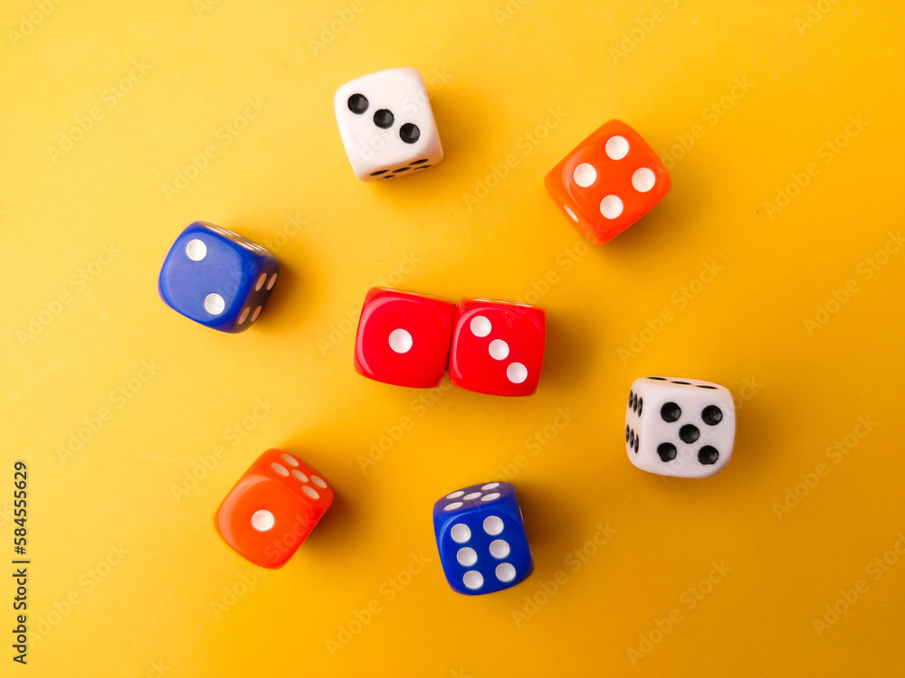 Top view Colored dice on a yellow background. Top view Colored dice on a yellow background.