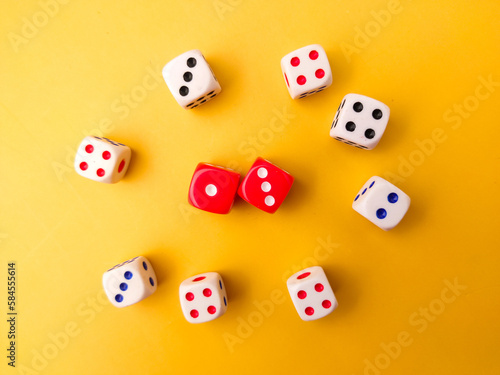 Top view Colored dice on a yellow background.
