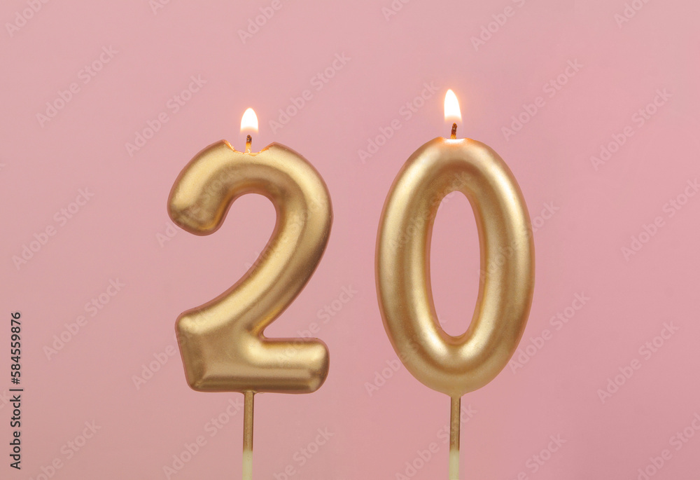 Burning golden birthday candles on pink background, number 20 - obrazy, fototapety, plakaty 