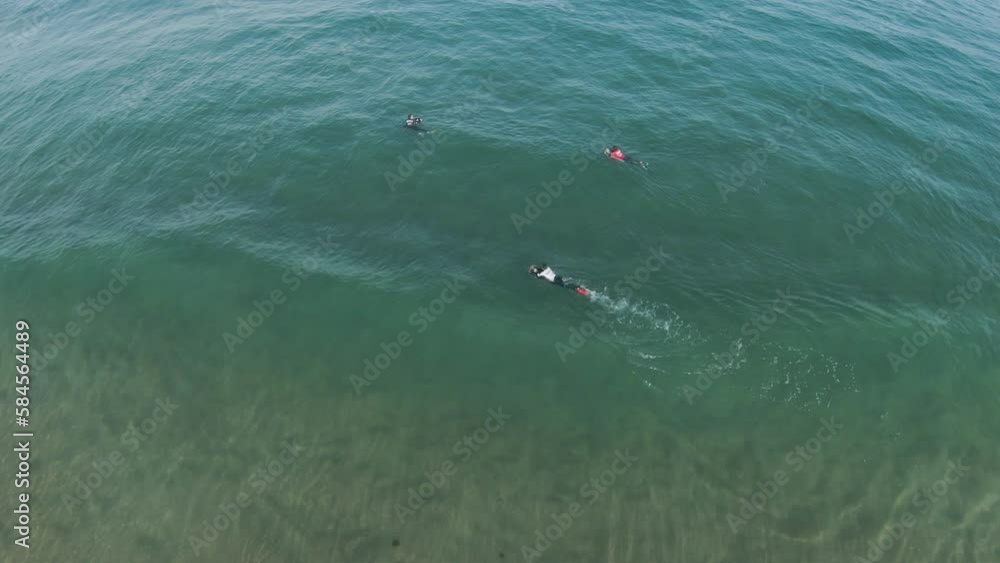 Slow motion aerial of rolling wave and bodyboarder swimming past Slow motion aerial of rolling wave and bodyboarder swimming past