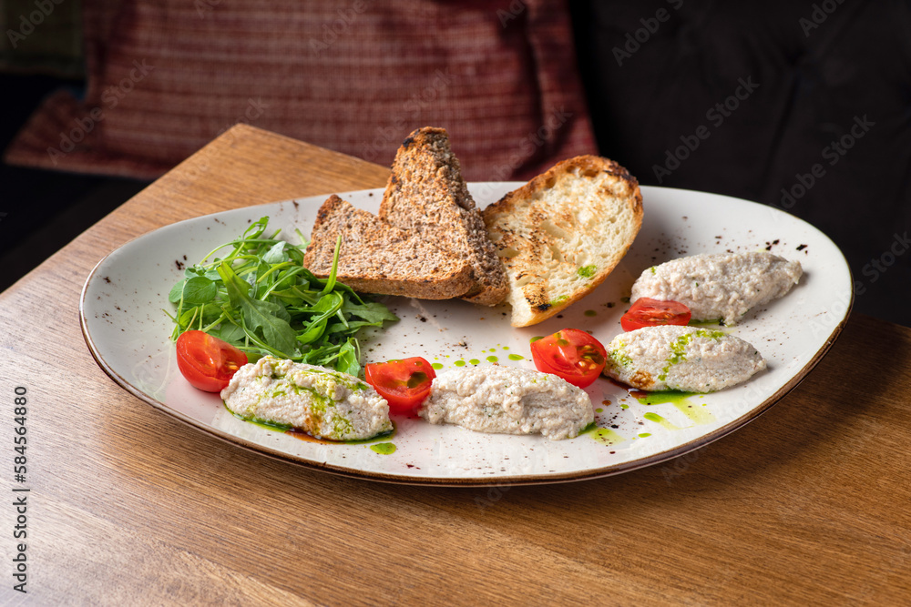 Cod liver pate with brown bread on plate. Homemade spread made from cod liver and cottage cheese Cod liver pate with brown bread on plate. Homemade spread made from cod liver and cottage cheese