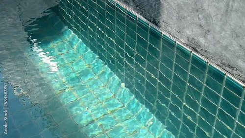 water wave slow motion of swimming pool on cement wall, construction industry