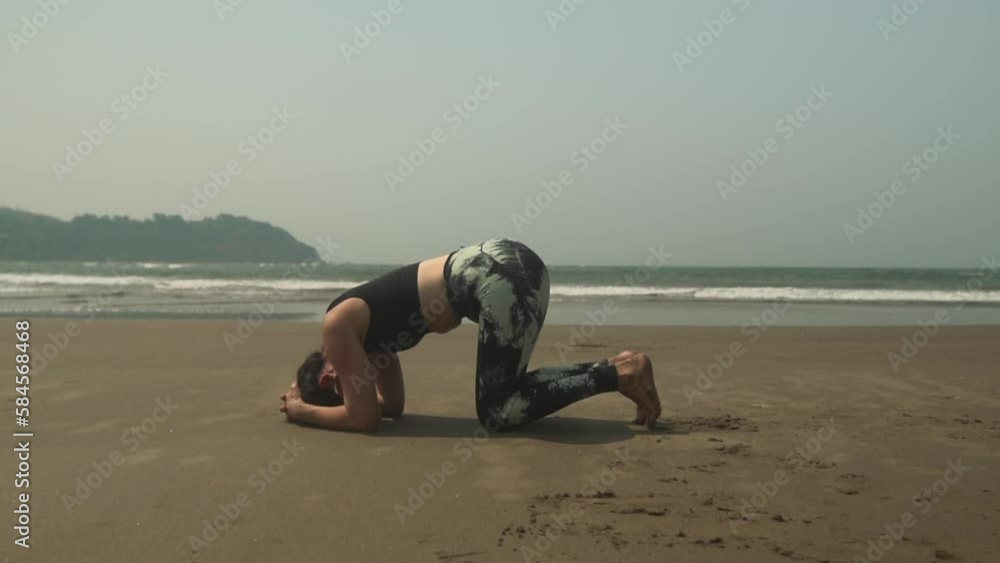 Yoga headstand position asana by young woman on beach outdoors exercise Sirsasana Yoga headstand position asana by young woman on beach outdoors exercise Sirsasana