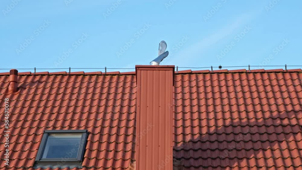 Red Tile Roof with Shiny Metal Rotating Chimney Cap Red Tile Roof with Shiny Metal Rotating Chimney Cap