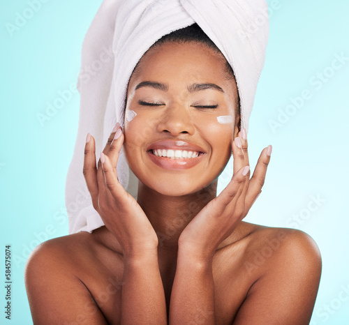 Skincare, beauty and lotion, black woman with smile on face for anti aging or skin glow on blue background. Cosmetics, facial and cream, African model with moisturizer or cleansing product in studio.