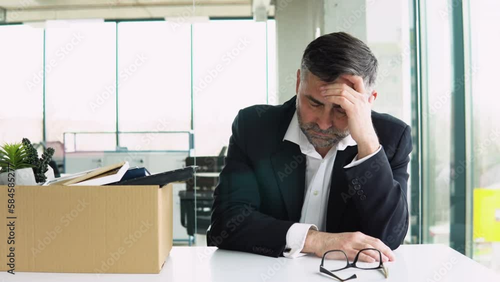 Old man is retiring. Senior employee sitting with dismissal box. Man by dismissal. Senior man lost job. Retirement concept Old man is retiring. Senior employee sitting with dismissal box. Man by dismissal. Senior man lost job. Retirement concept