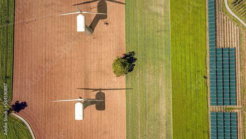 Overhead drone shot of wind turbines in a field.