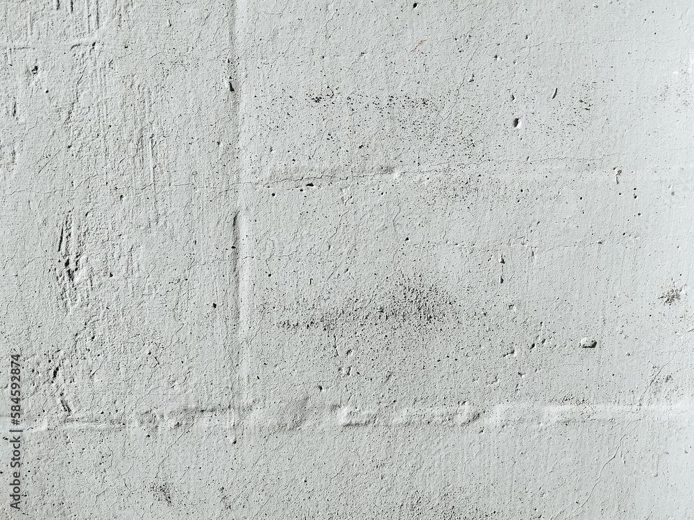 Grunge texture of a plaster white wall with damages and scratches. Old weathered surface.