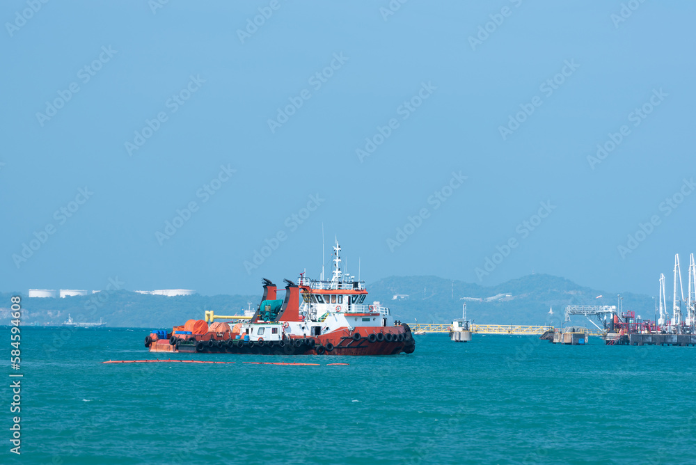 A tug boat while sailing along the coast awaits service.