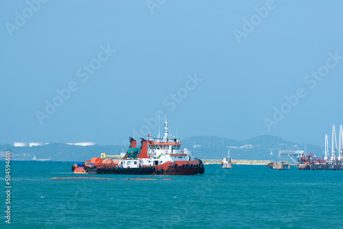 A tug boat while sailing along the coast awaits service.