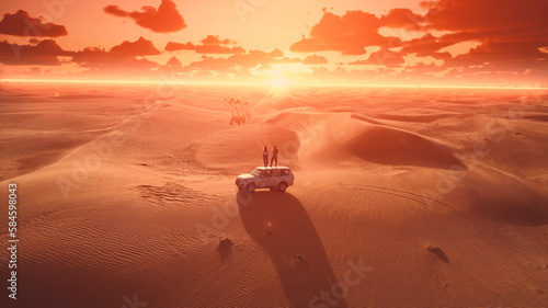 Aerial. Young travellers stands on the car roof and looks on the camels group on the sunset