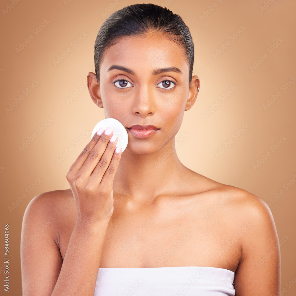 Beauty, serious and cotton with portrait of indian woman in studio for self care, makeup remover and cosmetics. Skincare, clean and glow with model on brown background for results, natural and facial Beauty, serious and cotton with portrait of indian woman in studio for self care, makeup remover and cosmetics. Skincare, clean and glow with model on brown background for results, natural and facial
