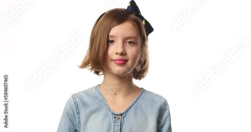 Teen girl child wearing jeans dress put hand on face facepalm in studio on white background, epic fail, amazed with stupid situation photo