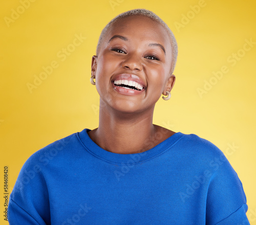 Black woman, smile and face portrait in studio for motivation, beauty and happiness and mindset. Young african aesthetic female model on a yellow background laughing for cosmetics and positive color © Joanrae/peopleimages.com