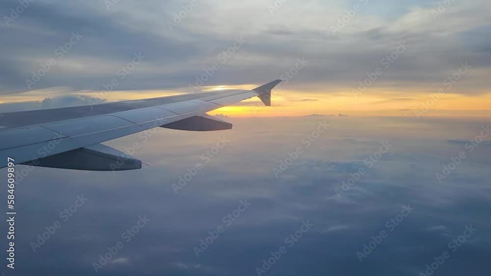 Cam tilt up, view of airplane wing during sunset Cam tilt up, view of airplane wing during sunset