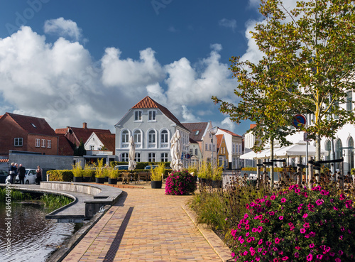 Cityscape of Tønder, Southern Denmark (Syddanmark). Lake near the old town with flowers around it. photo