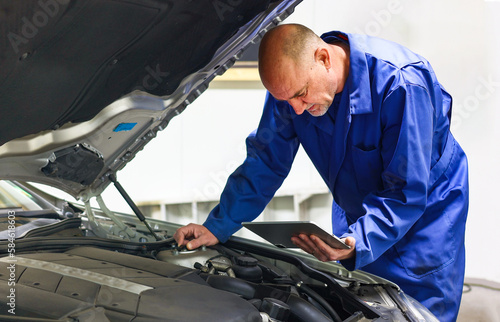 Car Mechanic Detailed Vehicle Inspection using digital tablet assistance the Inspecting the Vehicle, car technology Service Center Theme.