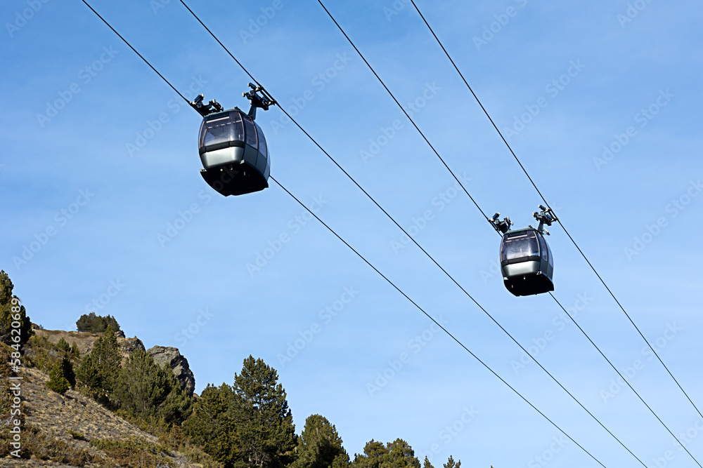 two cabins of funicular in high mountains, winter ski resort. Winter sports, recreation and travel two cabins of funicular in high mountains, winter ski resort. Winter sports, recreation and travel