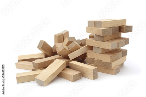 A game of wooden bricks in a half-destroyed state be on a white background. 