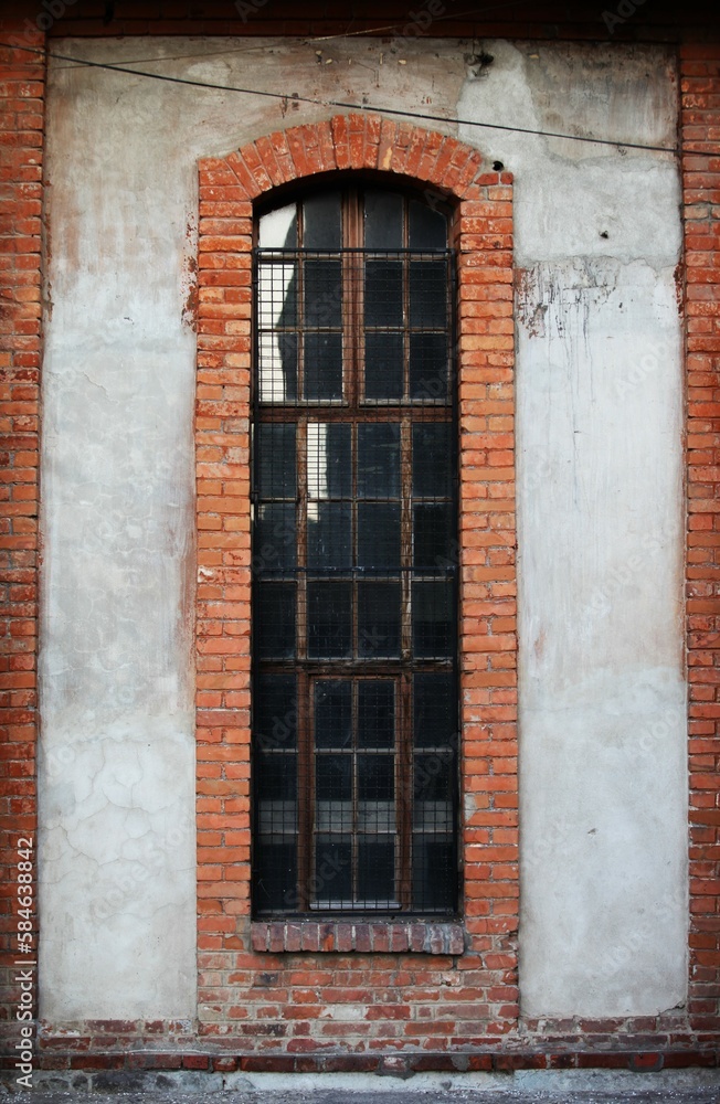 Red bricks around the windows of the old building, reflection on the windows Red bricks around the windows of the old building, reflection on the windows