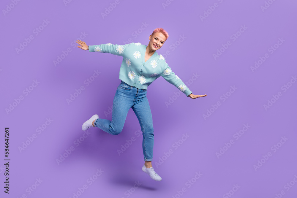 Full length photo of lightness carefree woman jump trampoline hands arms flying wings have fun sale advert isolated on purple color background