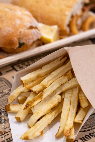 closeup photo of french fries in a cardboard cone. Food and fast food concept.