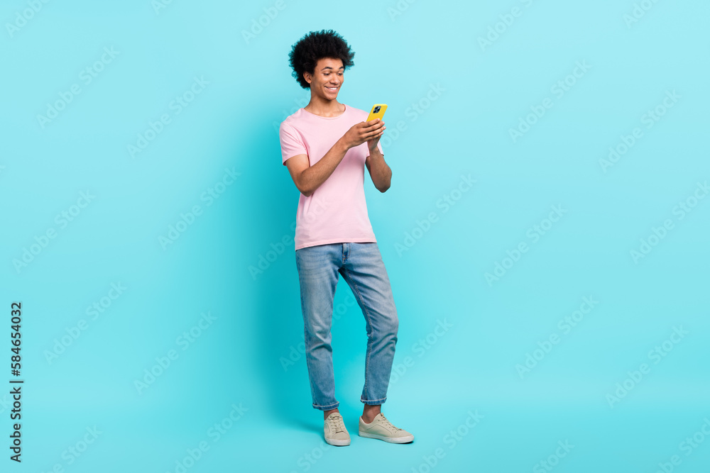 Full length body cadre of youngster handsome guy blogging read phone browsing google choose best offer isolated on aquamarine color background Full length body cadre of youngster handsome guy blogging read phone browsing google choose best offer isolated on aquamarine color background